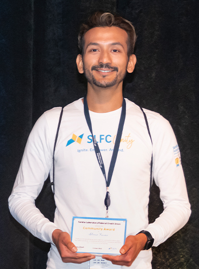 Adrian Franco posing with his Community Award 